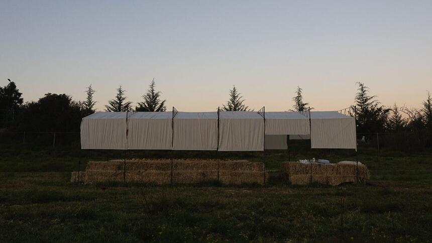 Side view of a temporary pavilion in the meadow